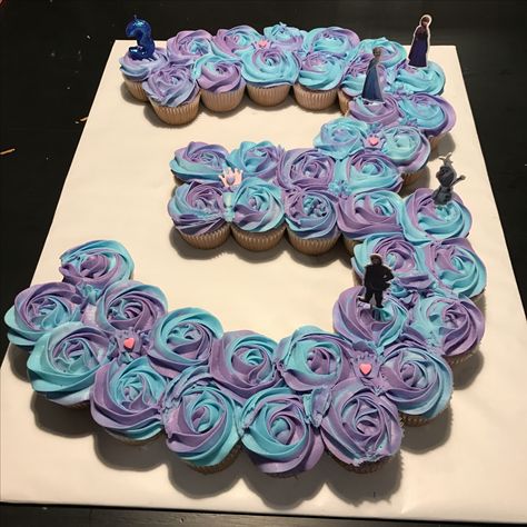 Frozen 3 cupcake cake for a third birthday with purple and blue two-toned icing! Frozen cake. Two toned cupcakes. Frozen birthday cake. 3 cupcake cake. Frozen Birthday Cupcakes Ideas, Frozen Birthday Cake And Cupcakes, Third Birthday Cupcakes, Frozen 3rd Birthday Party Cake, Frozen Themed Birthday Cupcakes, Diy Frozen Cupcakes, Purple Frozen Birthday Party, Purple 3rd Birthday Party, Frozen Cupcakes Ideas