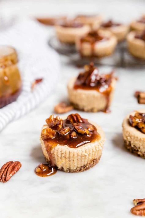 These mini pecan pie cheesecakes are gluten-free and grain-free with a spiced pecan crust and topped with a decadent pecan pie caramel sauce. Perfect for holiday entertaining! They're easy to make ahead and a delicious dessert for any party, whether you're hosting or bringing a dish to share. Skip the graham crackers and go with a pecan crust for these easy mini cheesecakes spiced with cinnamon. #glutenfree #entertaining #grainfree Easy Mini Cheesecakes, Mini Pecan Pie, Gluten Free Desserts Thanksgiving, Mini Cheesecakes Easy, Individual Cheesecakes, Pecan Crust, Mini Pecan Pies, Pecan Pie Cheesecake, Gluten Free Thanksgiving