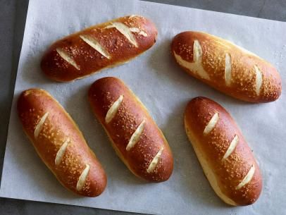 Pretzel Hot Dog Buns Recipe | Jeff Mauro | Food Network Pretzel Hot Dog Buns, Pretzel Hot Dog, Pretzel Bun Recipe, Pretzel Buns, Jeff Mauro, Pretzel Bun, Buns Recipe, Hot Dog Recipes, Bun Recipe