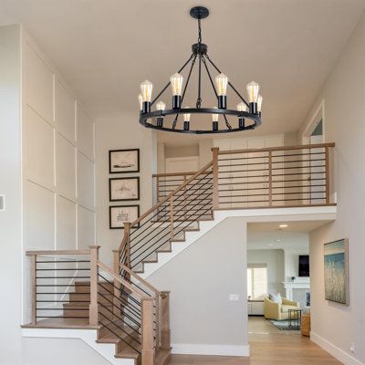 The farmhouse chandelier features a high-quality and durable black metal wagon wheel frame design, with a 10 light providing 360 ° light coverage, providing bright lighting for your decorative space. Metal black finish with exposed bulbs are blended for a rustic farmhouse feel with a modern edge. Multi-process to keep the bracket durable, with no rust, not easy to oxidize, stable, and long life. No matter where you place it, you will enjoy the fixture's soft illumination and beautiful look. | Gr Modern Farmhouse Chandelier Entry Way, Farmhouse Chandelier Entry Way, Modern Farmhouse Home Decor Ideas, Farmhouse Stairs Railing, Opening Up Under Staircase, Modern Farmhouse Chandelier Stairway, Split Stairway Chandelier, Modern Farmhouse Millwork, Open U Shaped Staircase