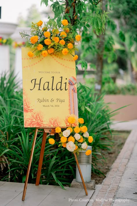 Haldi entrance standee, minimalist design, floral touch, wedding decor, wedding planning, wedding inspiration, Indian wedding, elegant entrance, simple decor, wedding festivities, sunkissed affair, subtle decor, yellow flowers, Haldi decor, Wedding invitations, Wedding entrance decor Haldi Standee Design, Poolside Haldi Decor, Simple Decor Wedding, Beach Sangeet, Haldi Entrance, Elegant Entrance, Haldi Decor, Standee Design, Wedding Entrance Decor