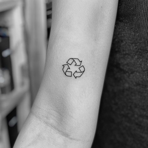 Embrace sustainability with a minimalist tattoo that makes a bold statement. This striking black ink symbol on the forearm, representing recycling, invites us all to commit to a greener planet. Let this be a reminder that every small action counts. Save for eco-inspiration and follow for more ways to live sustainably. #EcoTattoo #Sustainability #RecycleSymbol #MinimalistInk #GreenLiving #SaveThePlanet #EcoFriendly #AIimage Climate Tattoo, Environmentalist Tattoo, Sustainable Tattoo, Environment Tattoo, Recycle Tattoo, Earth Tattoo, Live Sustainably, Recycle Logo, Tattoo On Forearm