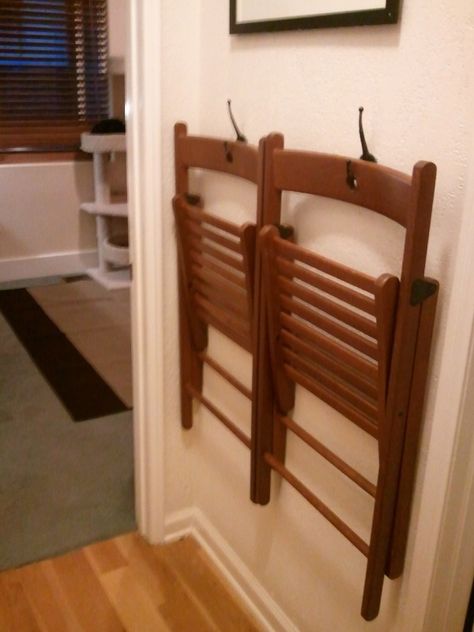 folding chairs hang on the wall in basement or on a metal cart, not on floor to avoid water damage*** Hang Chairs On Wall Garage, Chairs On Wall Display, Folding Chairs On Wall, Actual Farmhouse, Alpine Kitchen, Folding Chair Storage, Bungalow Furniture, Diy Hanging Chair, Fold Up Chairs