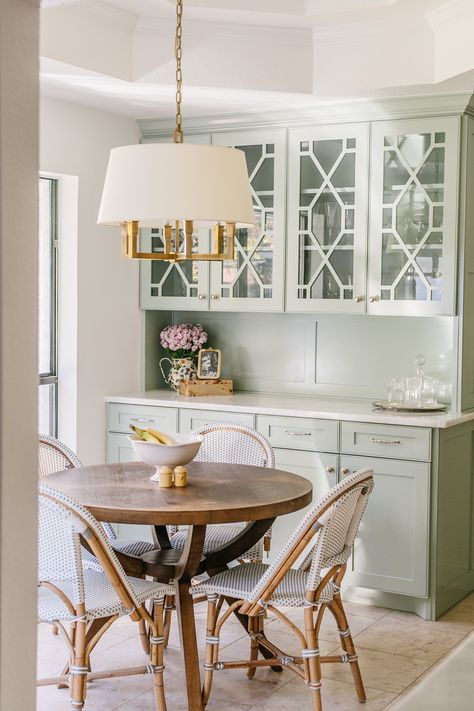 This home feels like stepping into a coastal grandmother's heaven. It includes true traditional details and materials - brass, woven textures, linen,  florals, etc. We love the cafe chairs and additional glass front cabinetry to store china, vases, etc.

Traditional Home, Coastal Grandmother, Grandmillennial, Traditional Style, Home Inspiration, Kitchen Inspo, Breakfast Nook, Charming Kitchen Breakfast Nook Art, Traditional Breakfast Nook, Feminine Farmhouse, Cozy Breakfast Nook, Farmhouse Kitchen Remodel, Kitchen And Bath Remodeling, Charming Kitchen, Glass Front Cabinets, Green Inspiration