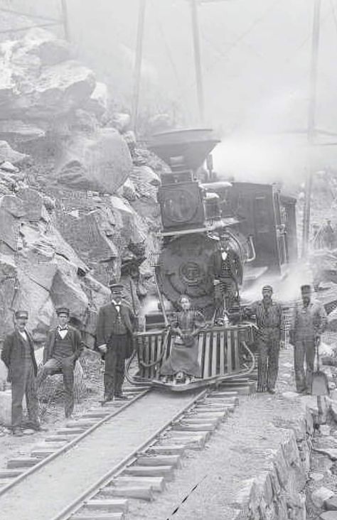 View of Colorado and Southern narrow gauge locomotive #7 (Cooke Locomotive works, 1884) downgrade under Georgetown Loop bridge, in Georgetown, Clear Creek County, CO. The conductor and brakemen are on the left; the fireman (in overalls) and engineer are on the right. A woman sits on the cowcatcher, and the Georgetown bridge supports show in the background Train Spotting, Bridge Support, The Fireman, Number Seven, Choo Choo Train, Fort Smith, Rail Car, Classic Truck, Steam Locomotive