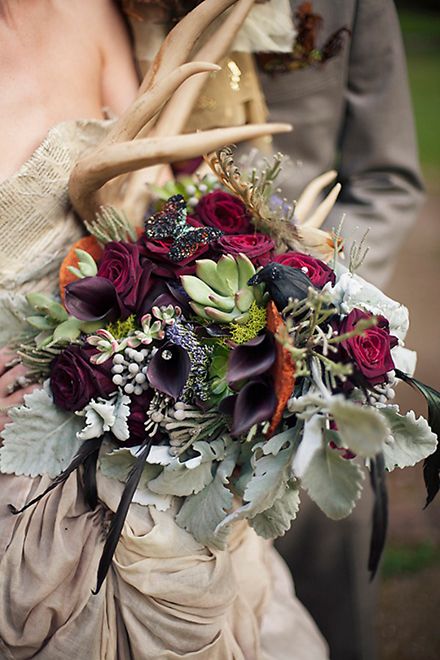 Antler dramatic bouquet with dusty miller, black calla lillies, red roses, succulents Woodland Wedding Bouquet, Pomegranate Wedding, Deer Antler Wedding, Nordic Wedding, Succulent Bouquet Wedding, Antler Wedding, Viking Wedding, Succulent Bouquet, Unusual Weddings