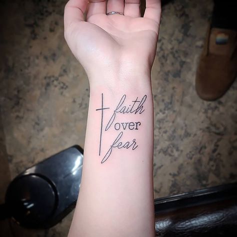 27 Spiritual Tattoo Ideas for Christian Women - Mom's Got the Stuff Tattoo About Faith In God, Women Scripture Tattoo, Tattoos Faith Christian, Christian Warrior Tattoos For Women, Saved Tattoo Christian, Word Tattoos On Arm, Faith Tattoo Designs, Fear Tattoo, Scripture Tattoos