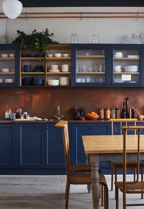 an impressive blue kitchen with a copper backsplash and a rich stained wooden countertop feels refined and vintage inspired Celebrity Kitchens, Navy Blue Kitchen, Navy Kitchen, Copper Backsplash, Blue Kitchen Cabinets, London Office, Blue Cabinets, Blue Kitchen, Copper Kitchen