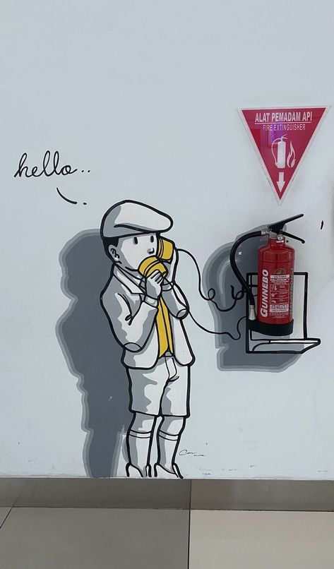 The boy speaks to the paper cup, but he listens to himself on the other end of the line.  What a silly way to communicate!

Fire extinguisher marking Wall Art Diy Paint, Coffee Shops Interior, Fire Extinguishers, Make Believe, Line At, Fire Extinguisher, Make Things, The Boy, Paper Cup