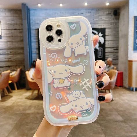 The Cinnamoroll Transparent Phone Case is a must-have for anyone who loves the Sanrio aesthetic. With its cute and whimsical design featuring one of Sanrio's most beloved characters, this phone case is the perfect way to show off your love for all things kawaii. But the real star of the show is the design itself. Cinnamoroll, with his fluffy ears and adorable face, is the perfect embodiment of the Sanrio aesthetic. And with other cute objects included in the design, this phone case is sure to br Cute Objects, Sanrio Aesthetic, Kawaii Iphone Case, Cute Ipad Cases, Girly Phone Cases, Kawaii Phone Case, Pretty Iphone Cases, Pretty Phone Cases, Transparent Phone Case