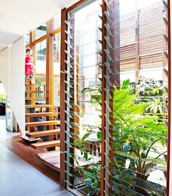 Light and air A long hallway connects the two parts of the house. Here, louvred windows from Stockwells Joinery keep the area well ventilated. The stair treads are made from recycled timber from Ironwood. ECO TIP Louvred windows are great for passive cooling. Up high, they let hot air out while down low they let cool air in. To keep warm in winter, make sure they seal properly to keep out draughts.: Jalousie Window, Louvre Windows, Tropical House Design, Passive Cooling, Louver Windows, Renovation Diy, Rest House, Tropical House, Diy Decorating