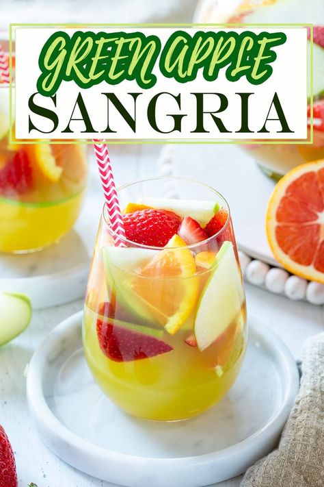 Looking for a refreshing fruity cocktail? Try this easy green apple sangria recipe! Crisp green apples, sweet white wine, and zesty lemon, make this the pitcher-perfect addition for pool parties, porch sippin,’ or girls night in. Olive Garden Apple Sangria Recipe, Green Apple Sangria Olive Garden, Olive Garden Sangria, Olive Garden Sangria Recipe, Green Apple Sangria, Green Apple Moscato Sangria, Moscato Sangria Recipes, Apple Sangria Recipes, Moscato Sangria