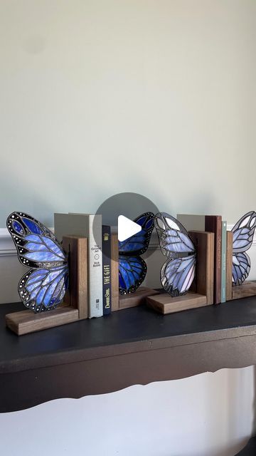 kel | camel city glass on Instagram: "Two new butterfly bookend sets were added to the roster this morning!🦋Whether you have three books or a double digit collection you want to show off, these sets were made to hold it all together and be a stunner at the same time🤩Which of these two do you like best? I gravitate towards the blue set but then that iridescent glass on the purple set catches the sun and I’m sold😍  Just a few more days until these are all released. I’ll give you an “all in one” view of all 12 sets tomorrow!  #glassbutterfly #bookends #instagramreaders #currentlyreading #bookshelfdecor" Butterfly Book Ends, Butterfly Bookends, Butterfly Books, Purple Set, Glass Butterfly, Bookshelf Decor, The Purple, This Morning, Bookends