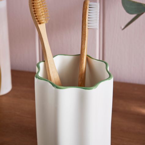 * Scalloped design * Green pop of colour * Matching items available Add a playful statement to your bathroom décor with this charming toothbrush holder, featuring a scalloped design, in a white colourway with a pop of green. A member of the Heart and Soul collection, this piece is available alongside matching items, allowing you to create a cohesive bathroom aesthetic. Tumbler Boho, Green And Pink Bathroom, Pink Bathroom Accessories, Ceramic Toothbrush Holder, Soap Colorants, Bathroom Tumbler, Scalloped Design, Bathroom Aesthetic, Green Pottery