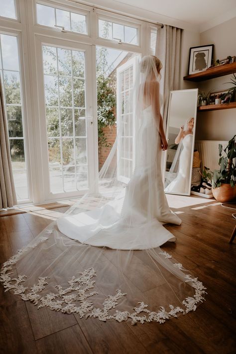 Bride in strapless button back wedding dress with a long veil with an embroidered edge Strapless Wedding Dress Veil, Long Wedding Veils With Hair Down, Button Back Wedding Dress, Wedding Dress With Long Veil, Pale Pink Bridesmaids, Embroidered Wedding Veil, Classic Black Tie Wedding, Pale Pink Bridesmaid Dresses, Long Lace Veil