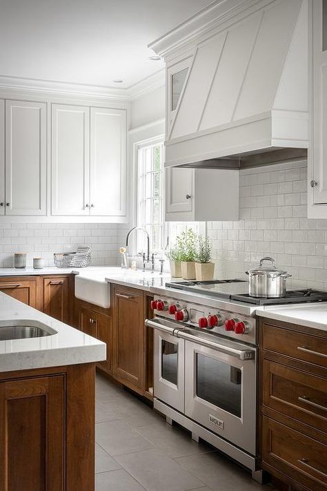 White upper cabinets with brown lower cabinets brings a stunning two-toned appeal to a transitional kitchen. White Upper Cabinets, Two Tone Kitchen Cabinets, Decorating Room, White Subway Tile Backsplash, Two Tone Kitchen, Casa Country, Brown Kitchens, Transitional Kitchen, Upper Cabinets