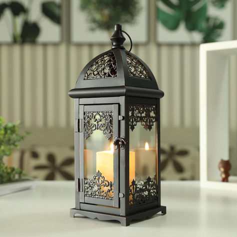 VINTAGE METAL CANDLE LANTERN - The life-size vintage candle lantern, with glass panes, special top and pattern frame distressed by white powdering UNIVERSAL SIZE FOR MOST OCCASION- Uses tea-light, real candles, votive or small pillar candles up to 3" x 4". 5.5" x 5.5" x 15" tall.Iron and glass.VERSATILE & PORTABLE - A hanging ring for easy hanging, or sits on a flat surfaceLightweight (2.1lbs), convenient to carry around TEMPERED GLASS PANES & DURABLE METAL Four clear tempered glass panes Large Floor Lanterns, Floating Candles Halloween, Metal Candle Lanterns, Floor Lantern, Alcohol Lamp, Electronic Candles, Lantern Candle Decor, Candle Lantern, Lantern Design