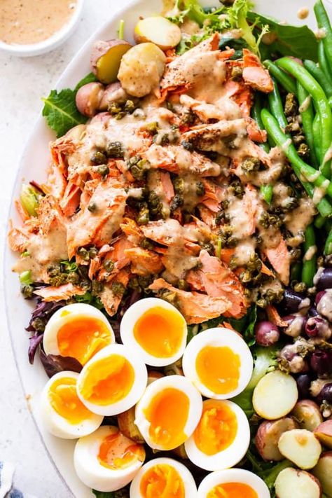 A delicious variation on the classic tuna Niçoise salad, this version includes tender salmon, crispy tender green beans, hearty potatoes and a delicious dressing that takes the salad to the next level. Paleo with a Whole30 option, this salad is sure to become a new favorite. #paleo #whole30 #cleaneating #salad #salmon Salmon Crispy, Salmon Nicoise Salad, Salad Salmon, Tuna Nicoise Salad, Paleo Running Momma, Paleo Salmon, Hot Bacon Dressing, Light Cooking, Parties Food