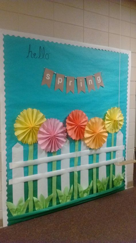 Hello Spring bulletin board with rope swing Spring Season Decoration Ideas For School, Spring Decoration School Hall, Spring Hanging Decorations Classroom, Hello Spring Decor, Hello Spring Bulletin Board, Spring Cubicle Decor Ideas, Spring Wall Decor Classroom, Spring Display Ideas Classroom, Spring Bulletin Board Ideas For Work