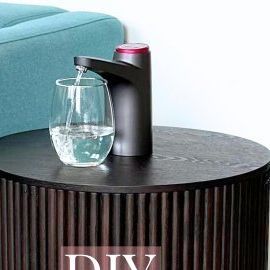 Andreja Juknevicius on Instagram: "Definitely an upgrade 👌🏻 Comment DIY and I'll send you the link directly! Or find everything you need for this DIY table under ✨ Home Finds ✨ on my website 👉🏻 LINK IN BIO (andrejaelena.com) 🤍 . . How convenient and beautiful is this dispensing table with built in storage for your water jug?! 😍 If you would like to make one too, everything you need is linked on my website under Home Finds and the directions are here 👇🏻 I also have one that uses a different table that is white. . DIY Instructions: 1) Use the 2 1/4" hole saw (with a drill) to cut a hole at the top of the table 2) Place the 1" pan upside down at the bottom for additional height 3) Place the water dispenser on top (please note: the water dispenser will not sit firmly on top of the tabl Diy Water Dispenser Stand, Dispensing Table, Water Dispenser Stand, Home Finds, Diy Water, Diy Furniture Renovation, Furniture Renovation, Table 2, Hole Saw