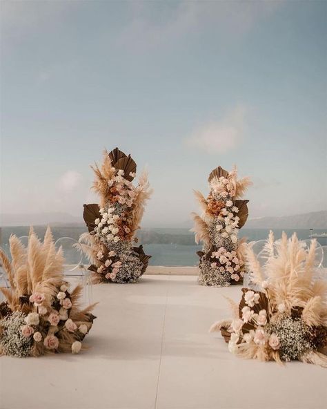 Let the natural colors and textures weave their magic as you say your vows surrounded by gorgeous boho installations like these! | wedding planning, outdoor wedding decor, outside wedding decor, wedding aisle decor, wedding ceremony decor, boho wedding, bohemian wedding decor, wedding flowers, wedding floral designs, boho floral arrangements, boho wedding inspo, summer wedding, summer wedding decor, outdoor wedding ceremony, boho floral designs, bohemian bride #summerwedding #weddingceremony Boho Modern Wedding, Bohemian Wedding Ceremony, Ceremony Altar, Bohemian Wedding Theme, Summer Wedding Decorations, Boho Beach Wedding, Ethereal Wedding, Portugal Wedding, Santorini Wedding