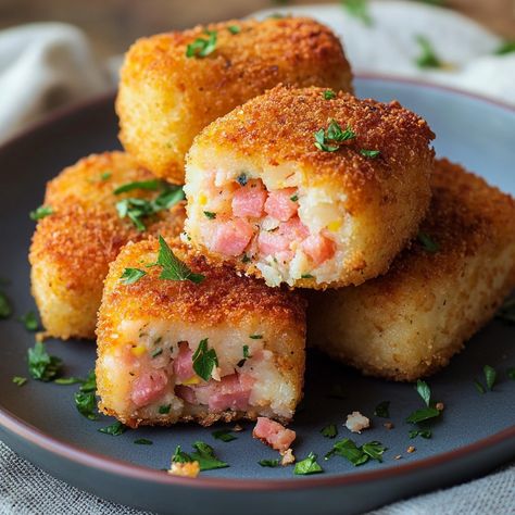 🥔🥓 Recipe: Ham and Potato Croquettes 🥓🥔 Ingredients: 500g potatoes 150g diced ham 1 egg 100g grated cheese 50g flour Breadcrumbs Salt and pepper Oil for frying Instructions: Cook the potatoes in water until tender. Drain and mash them. In a bowl, mix the mashed potatoes, ham, cheese, egg, flour, salt and pepper. Form small balls or croquettes with the mixture. Roll each croquette in breadcrumbs. Heat the oil in a frying pan and simmer the croquettes until golden on each side. Drain on abso... Ham And Potato Croquettes, Mashed Potato Croquettes, Ham Croquettes, Potato Rolls Recipe, Fried Ham, Mashed Potato Balls, Cheese Mashed Potatoes, Potato Croquettes, Potato Roll