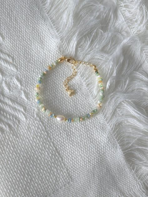 FOR OTHER DAINTY BEADED BRACELETS: https://www.etsy.com/ca/shop/ArtiChouXCanada?ref=seller-platform-mcnav§ion_id=46088511 Bracelet Length: 13-18cm (5.1-7 inches) with a 14k gold filled or sterling silver extender. This bracelet features an assortment of pastel colors: green, yellow, blue, cream, white, and 18k gold filled or sterling silver seed beads. It also contains a freshwater pearl.  Thread may be visible since it is a handmade product   SIZING  Wrap a soft measuring tape snugly around the Cheap Green Bracelets With Tiny Beads, Pretty Seed Bead Bracelets, Silver And Gold Beaded Bracelet, Dainty Bead Bracelets, Bracelet Patterns Seed Beads, Green Seed Bead Bracelets, Pastel Beaded Bracelets, Small Glass Bead Bracelet, Dainty Beaded Bracelets