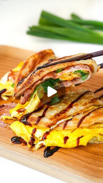 Christian Ou on Instagram: "✨SAVE RECIPE✨ CHEESY SCALLION PANCAKE BREAKFAST SANDWICH: Breakfast is my favorite meal of the day. Growing up in Taiwan, I used to eat scallion pancake as a snack! I love adding different toppings and fillings to it. Would you eat this scallion pancake for breakfast? 

Ingredients:
Scallion Pancake (I got it from @99ranchmarket )
2 eggs
2 scallion, chopped
2 slices of bacon
1 cup shredded cheese (I used mozzarella)
salt

Directions:
1. In a pan, heat 2 tbsp of oil. Add frozen scallion pancake and pan fry until golden brown and crispy on both sides. Set it aside.
2. Next, cook the bacon until crispy and set it aside.
3. In a small bowl, add 2 eggs and a pinch of salt and mix with a fork or whisk. Pour the egg into the pan. Then add chopped scallion, shredded che Scallion Pancake Wrap, Scallion Pancakes Korean, Japanese Scallion Pancake, Scallion Pancakes Chinese, Sandwich Breakfast, Egg Wrap, Pancake Breakfast, Asian Meals, Scallion Pancakes