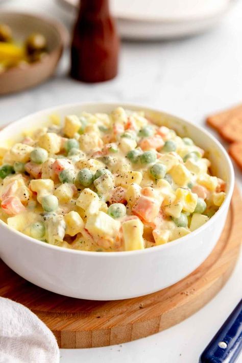 Olivier Salad is a vegetarian salad recipe for a Russian classic made of potato, mayo, eggs, peas, and carrots. A simple and quick recipe for a divine dish. This Russian classic goes from pantry to table in 30 minutes and it's great for vegetarian and gluten-free diet. #jernejkitchen #russiansalad #saladrecipes #oliviersalad Salad Names, Olivier Salad, Vegetarian Salad, Peas And Carrots, Vegetarian Salad Recipes, Fair Food, Vegetarian Salads, Yummy Salad Recipes, 30 Minute Meals