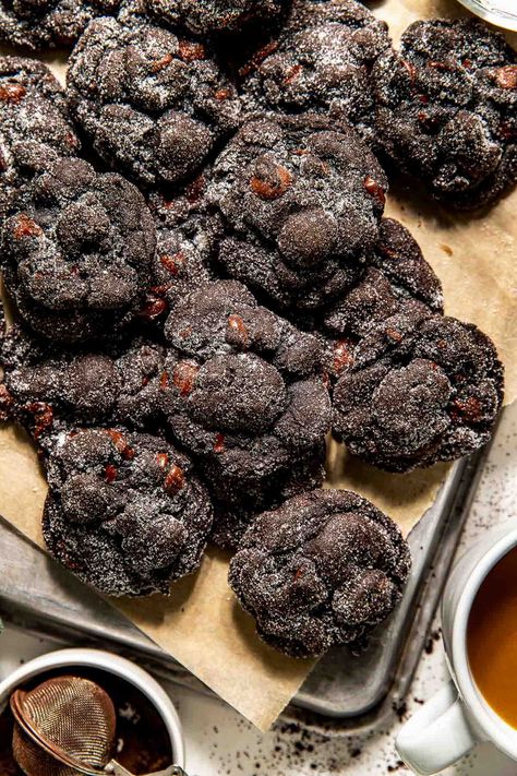 Being on Santa's Naughty List has never been sweeter! These Lumps of Coal Cookies have craggy edges, a fudgy center, and rich flavor from black cocoa and bittersweet chocolate chips. Rolled in sugar and baked just until set, they’re the perfect treat for holiday cookie plates or festive hot cocoa breaks! #lumpofcoal #lumpofcoalcookies #christmascookies #christmascookieideas #christmascookieexchange #holidaytreats #holidaybaking #cookierecipes #blackcocoapowderrecipes #blackcocoacookies Christmas Coal Cookies, Lump Of Coal Cookies, Coal Cookies, Lumps Of Coal, Lump Of Coal, Cocoa Powder Recipes, Christmas Coal, Black Cocoa, Cocoa Cookies