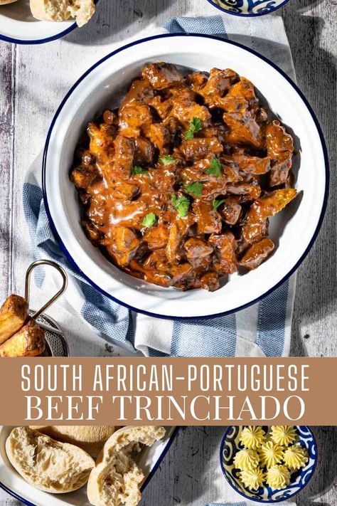 Trinchado in a white bowl with a dish of bread rolls and a small basket of chips. South African Beef Stew, Trinchado Recipe, Beef Trinchado, African Beef Stew, African Stew, South African Dishes, Cubed Steak, The Stew, Banting Recipes