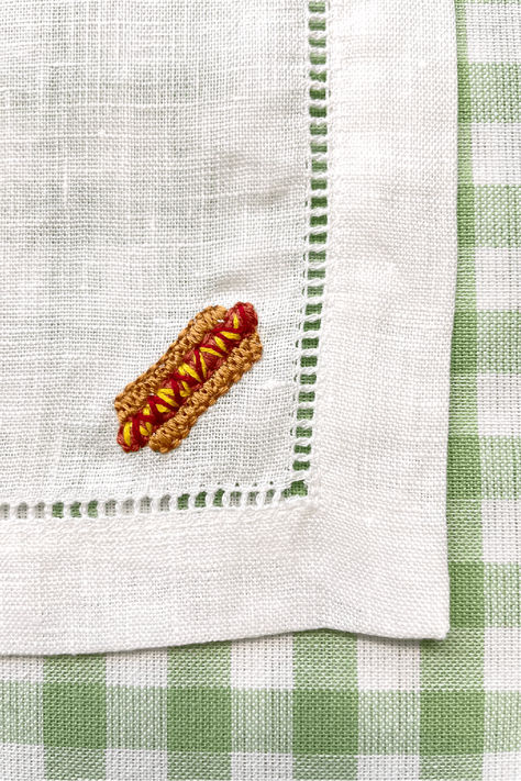 Hand embroidered hot dog design in corner of white linen cocktail napkin in front of white and green checkered background Hot Dog Embroidery, Dog Watermelon, Dog Cocktail, Embroidered Cocktail Napkins, Dog Embroidery, Linen Cocktail Napkins, Summer Foods, Cocktail Napkin, Hand Embroidery Projects