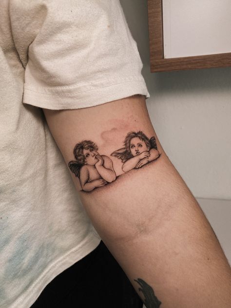 Cherub Tattoo Raphael’s Angels Tattoo, Raphael Cherubs Tattoo, Sistine Madonna Tattoo, Cherubs Holding Hands Tattoo, Raphael Angel Tattoo, Angel Wrist Tattoo, Madonna Tattoo, Notes Tattoo, Angels Tattoo