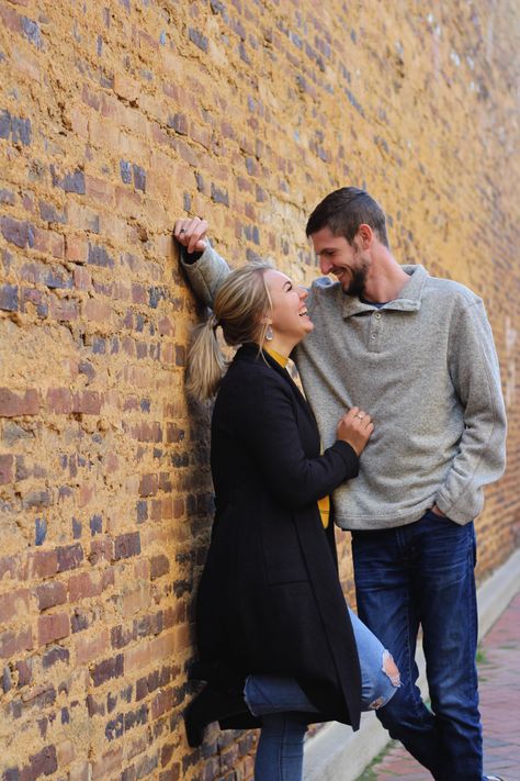 brick wall, smile, fall, couple, engaged, happy Leaning Couple Pose, Engagement Photos With Brick Wall, Brick Wall Couple Photoshoot, Couple Poses Against Wall, No Touch Couple Poses, Brick Wall Engagement Pictures, Brick Wall Wedding Photos, Engagement Photos Brick Wall, Older Couple Photoshoot Poses Outdoors