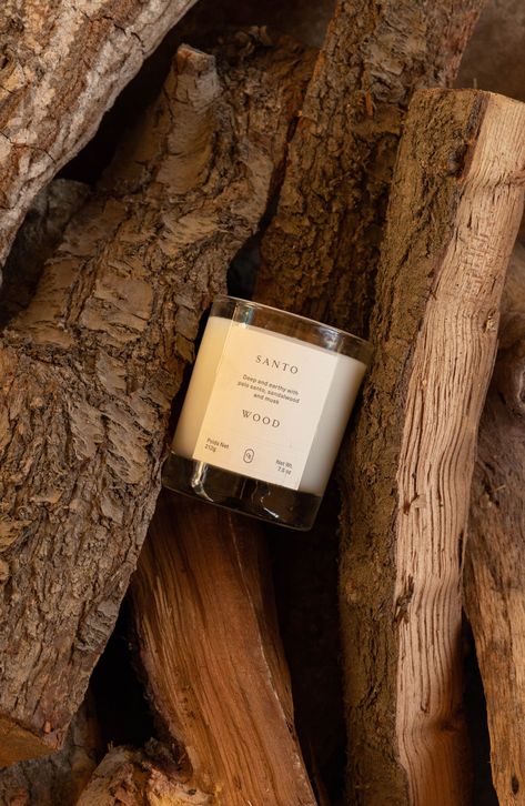 What it is: A woody and musky candle that seamlessly diffuses to create a signature scent personality in every room.Fragrance story: Santo Wood falls within the woody musk fragrance category and combines the highest quality materials sourced from the best growers in the world. Style: Woody, aromatic. How to use: Trim wick to 1/4" before each burn. Never leave candles unattended and don't burn for more than 4 hours at a time. When 1/4" of unmelted wax remains, discontinue use. 7.5 oz. Paraben-fre Fall Candle Photoshoot, Aesthetic Candle Photography, Luxury Candle Photography Ideas, Moody Candle Photography, Brown Candle Aesthetic, Candle Setup Ideas, Candle Advertising Ideas, Candle Business Aesthetic, Candle Ads