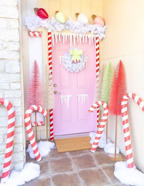 A pastel wonderland. Complete with fun pastels and giant candy canes and bulbs, this front door designed by Sam from Aww Sam is as inviting as it gets! House Door Decor, Gingerbread House Door, Christmas Door Decoration, Gingerbread Christmas Decor, Gingerbread House Decorations, House Door, Christmas Yard Decorations, Pink Christmas Decorations, Christmas Yard