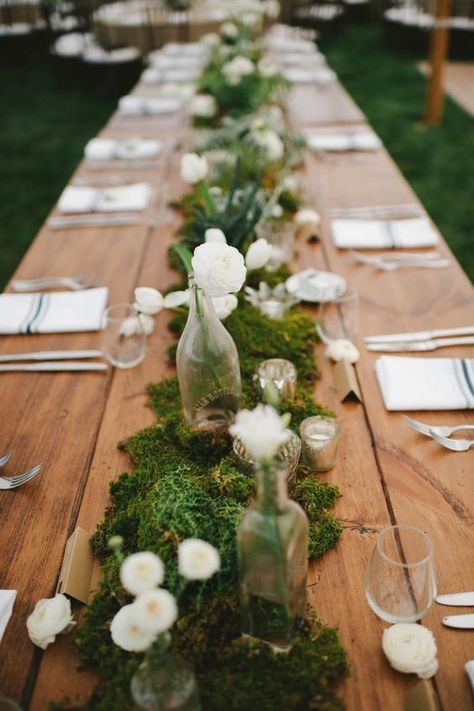 moss table runner decorated with white flowers, bottle vases and candles                                                                                                                                                                                 More Moss Wedding Decor, Moss Table Runner, Moss Centerpieces, Back Garden Wedding, Moss Wedding, Romantic Backyard, Long Table Wedding, Tafel Decor, Outdoor Dinner