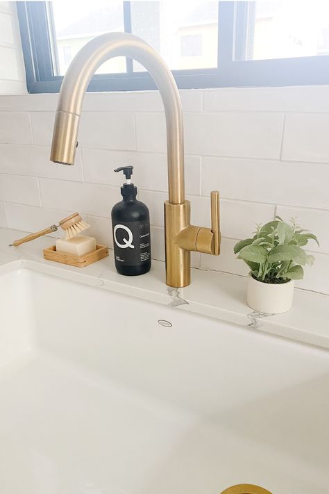 Gold Sink Hardware, Best Gold Kitchen Faucet, White Undermount Kitchen Sink Gold Faucet, White Sink With Gold Faucet, Kitchens With Gold Faucets, Gold Kitchen Faucet Farmhouse Sinks, Kitchen Sink Fixtures, Brush Gold Kitchen Hardware, Farmhouse Sink With Gold Faucet