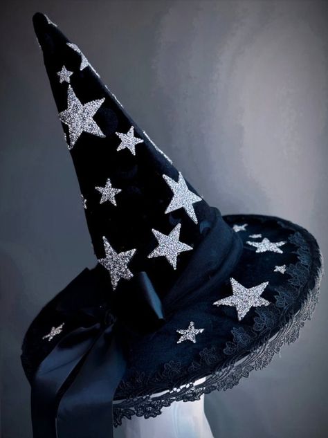 This bewitching black witch hat is adorned with glittering silver stars and delicate lace trim, perfect for those looking to shine with a touch of elegance at their next Halloween event. Age Group/Gender - Adult/Unisex Size/Type - One size fits all adults Hat Base Color - Black Hat Material - Fabric