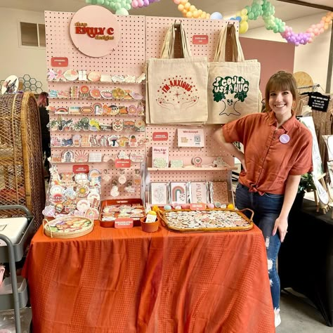 @shop.emilyc.designs shared a photo on Instagram: “MARKET DAY!🧡 I just realized I’ve worn orange to every single market. Can you tell it’s my favorite color?😄 come visit me at the…” • Apr 16, 2022 at 3:47pm UTC Craft Store Booth, Single Table Vendor Booth, Art Display Booth Ideas, Photography Pop Up Shop, Aesthetic Etsy Shops, Colorful Booth Design, Art Market Stall Display Ideas, Pop Up Market Set Up Ideas, Art Market Set Up