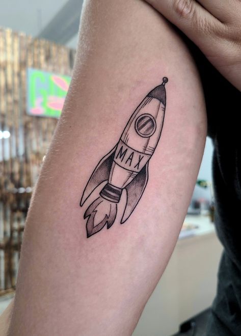 Inner arm tattoo of a rocket ship with my sons namw Traditional Rocket Ship Tattoo, Tattoo With Sons Name, Small Rocket Tattoo, Space Rocket Tattoo, Rocket Tattoo Design, Rocketship Tattoo, Retro Tattoo Ideas, Fred Tattoo, Rocket Ship Tattoo