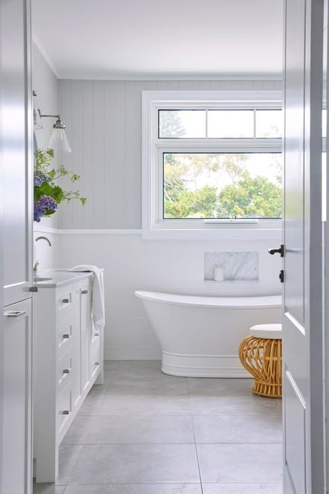 Classic neutral bathroom blending Queenslander style in timber-lined walls with VJ panelling above wainscoting with a freestanding bathtub and Shaker-style vanity cabinetry. Hamptons Style Bathroom, Hampton Style Bathrooms, Hamptons Bathroom, Classic Bathroom Design, Bathroom Freestanding, Hampton Style, Cottage Bathroom, Bathroom Redesign, Classic Bathroom