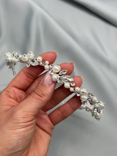 Glam meets classic bridal elements in our Samantha Pearl Headband. Hand wired vines of pearls & crystals elegantly curve along this headpiece for an ethereal look on your wedding day. Off white pearls & crystals Measures .5" at the widest point Pin loops are located at each end for extra security with bobby pins Sturdy yet flexible to comfortably shape to your hairstyle Style #3443 Pearl Bridal Tiara, Wedding Hair Accessories Headpieces, Simple Headpiece, Diy Shoes Heels, Wedding Hair Crown, Crown Hairstyle, Bridal Hairband, Pearl Headpiece Wedding, Pearl Headband Wedding