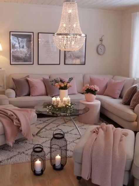 a modern girlish space with neutral walls, a neutral corner sofa and matching chairs, mauve and pink pillows and blankets and candle lanterns plus a gorgeous chandelier Feminine Living Room, Pink Living Room Decor, Apartment Living Room Design, Pink Living Room, Living Room Design Decor, Living Room Decor Cozy, Home Design Living Room, Apartment Decor Inspiration, Room Style