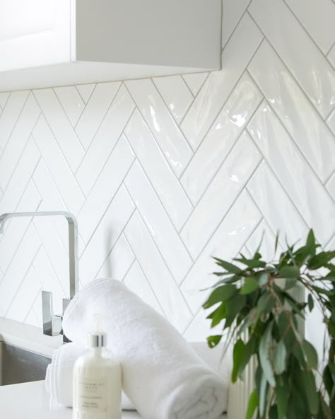 Herringbone Backsplash Laundry Room, Chevron Tile Laundry Room, Herringbone Backsplash Peel And Stick, White Kitchen With Herringbone Tile, Herringbone Tile Laundry Room, White Double Herringbone Tile Bathroom, Hampton Style Tiles Kitchen Backsplash, Large White Tiles Kitchen, Kitchen Tiles Herringbone