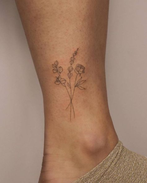 Fine line flower bouquet tattoo located on the ankle. Dainty Floral Bouquet Tattoo, Mini Bouquet Flowers Tattoo, Single Line Flower Bouquet Tattoo, Small Boquetes Of Flowers Tatoos, Line Work Flower Bouquet Tattoo, Fine Line Tattoo Snowdrop, 3 Inch Fine Line Tattoo, Fine Line Flower Bunch Tattoo, Little Flower Bouquet Tattoo