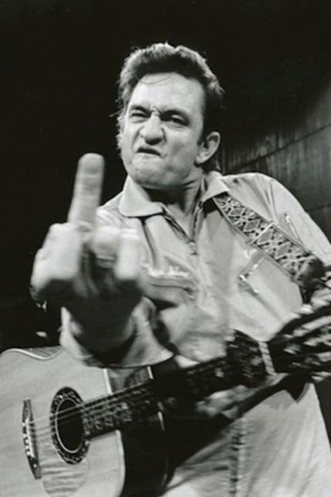 Remembering Johnny Cash (February 26, 1932 – September 12, 2003). Read our tribute to the greatest storyteller now. Johnny Cash Middle Finger, Middle Finger Picture, Finger Photo, Flipping The Bird, Jim Marshall, San Quentin, The Warden, Music Photographer, Guitar Painting