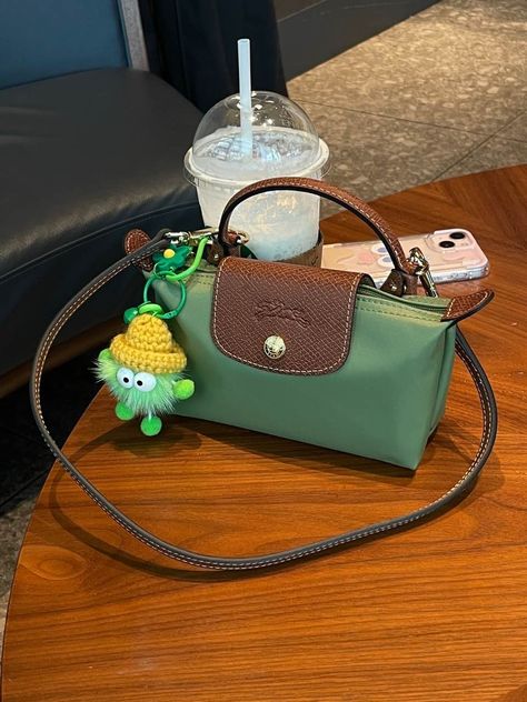 This green is really suitable for summer!!!Add two modification buckles and then add the shoulder strap.Turning into underarms bag.Then hang a green coal ball pendant,the pendant is so cute! Longchamp Bag Strap, Long Champ Bag Aesthetic, Green Purse Outfit, Mini Longchamp Bag, Longchamp Pouch, Green Bag Outfit, Long Champ Bag, Longchamp Mini, Y2k Handbag