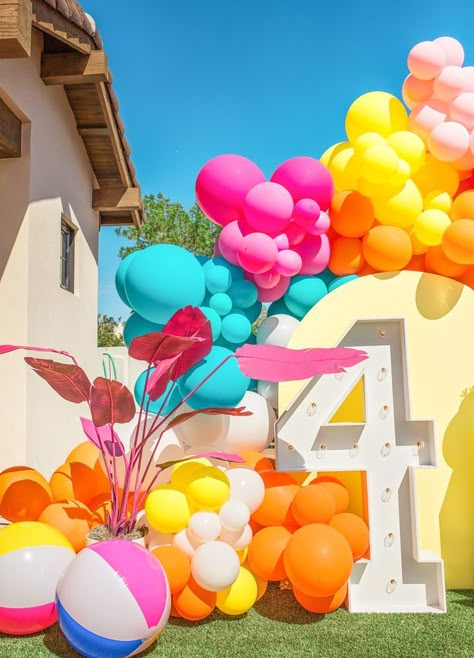 Malibu Barbie backdrop with yellow wooden arch, 4 marquee light, and pink, blue, orange, yellow and white balloon garland. Pink palm tree and beach ball inflatables. Marquee light, marquee number 4, spray paint pink palm tree, beach ball, colorful balloon garland, malibu barbie ideas, scottsdale arizona Barbie 4th Birthday Party, Barbie Party Backdrop, Barbie 4th Birthday, Malibu Barbie Party, Balloon Garland Pink, Barbie Backdrop, Beach Ball Birthday, White Balloon Garland, Beach Ball Party