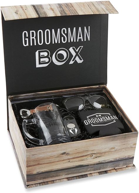 Can’t decide on one specific gift? Give a groomsmen gift box with a few small items or a set of items that go together. One popular groomsmen gift box idea is a nice wooden box with a small bottle of whisky, a nice, possibly engraved glass, and their preferred mixer. Groomsmen Kit, Groomsmen Boxes, Groomsman Proposal Box, Groomsmen Gift Box, Wedding Kit, Be My Groomsman, Wedding Gifts For Groomsmen, Wine Gift Baskets, Groomsmen Proposal